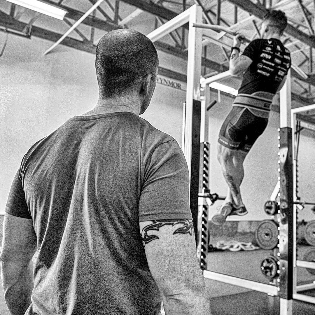 Chris Dellasega providing strength and conditioning coaching to four-time world record holder track cyclist Ashton Lambie.