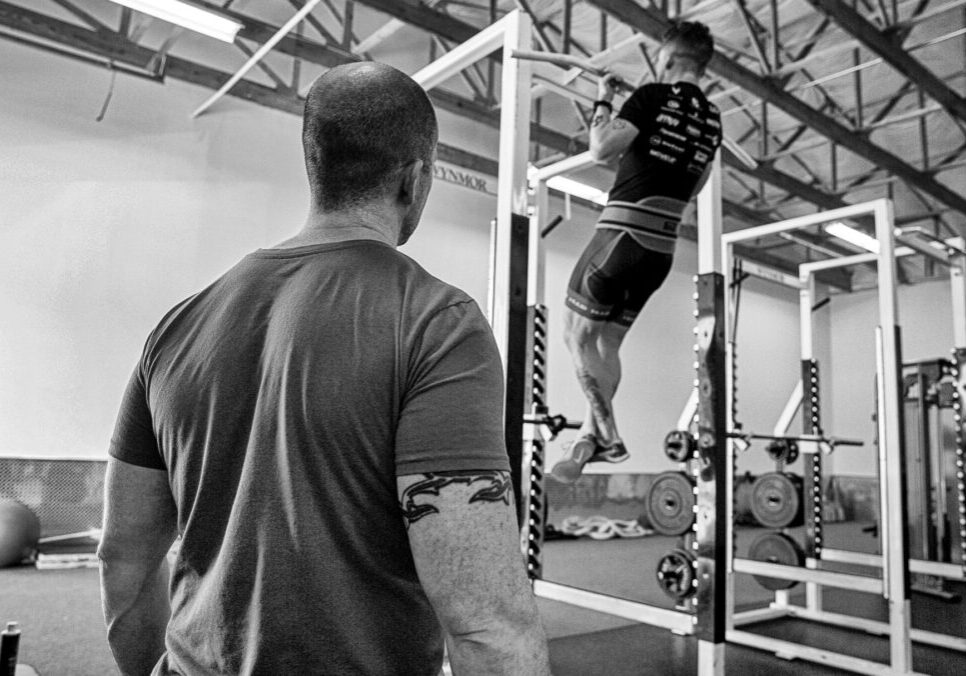 Chris Dellasega providing strength and conditioning coaching to four-time world record holder track cyclist Ashton Lambie.